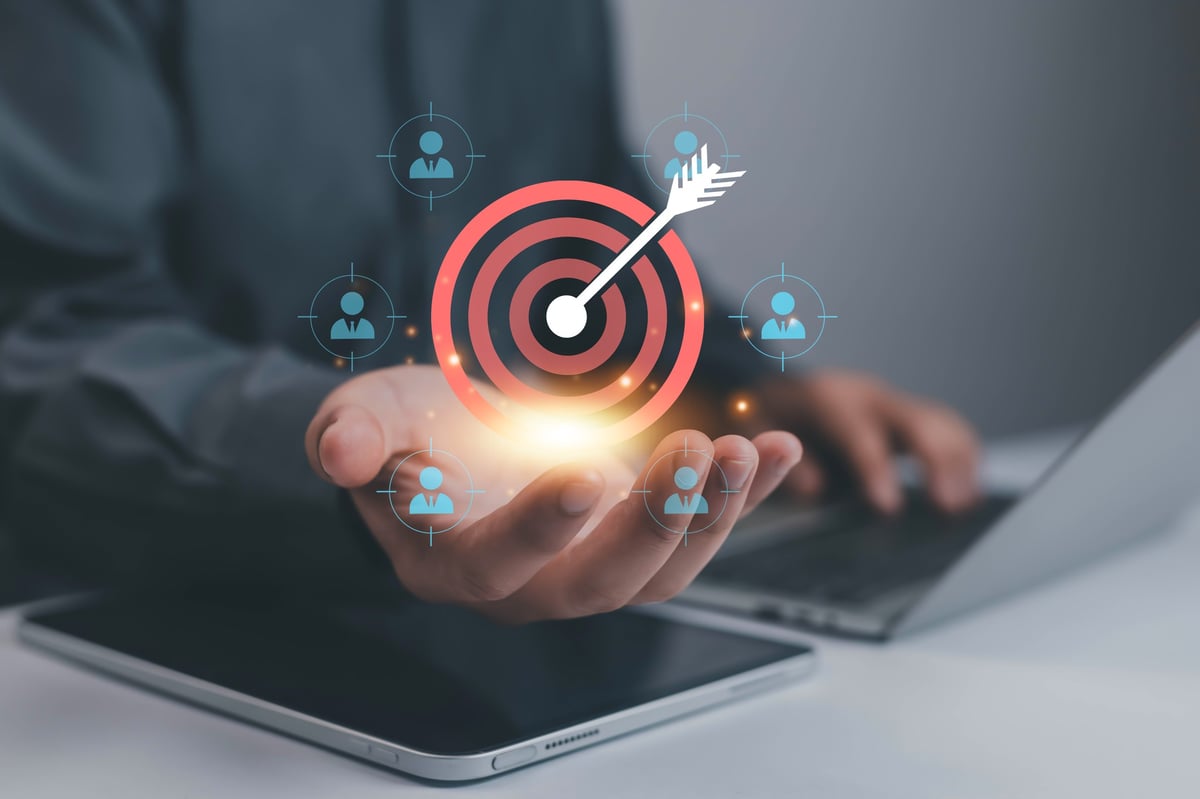 Businessman holding target with dart arrow symbol